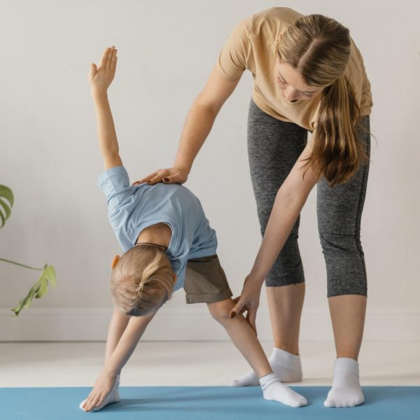 full-shot-woman-helping-kid-exercise